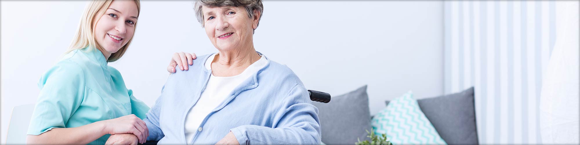 Caregiver Sitting with Happy Senior